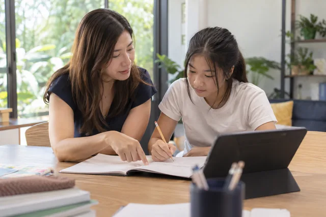 A tutor working through notes with a student
